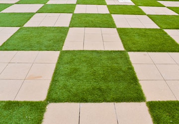 Pavers with artificial turf in a checkerboard pattern