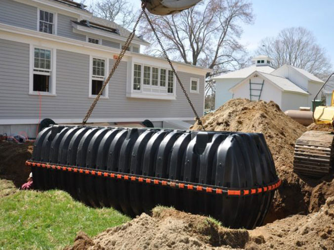 Septic tank being lowered into the ground
